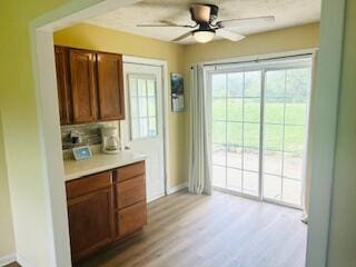 127 Circle St, London, KY 40744 - kitchen with baseboards, light countertops, ceiling fan, tasteful backsplash, and light wood-style floors