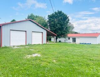 127 Circle St, London, KY 40744 - view of grassy yard with a garage and an outbuilding