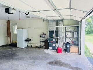 127 Circle St, London, KY 40744 - garage featuring a garage door opener and water heater