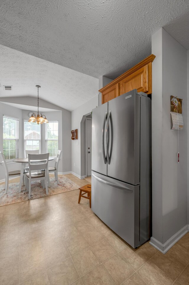 408 Joseph Bryan Way, Lexington, KY 40514 - kitchen featuring freestanding refrigerator, lofted ceiling, a textured ceiling, baseboards, and a chandelier