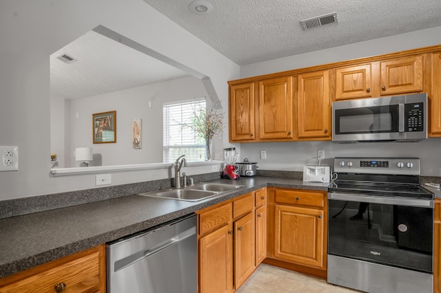 408 Joseph Bryan Way, Lexington, KY 40514 - kitchen with appliances with stainless steel finishes, a sink, dark countertops, brown cabinets, and light tile patterned floors