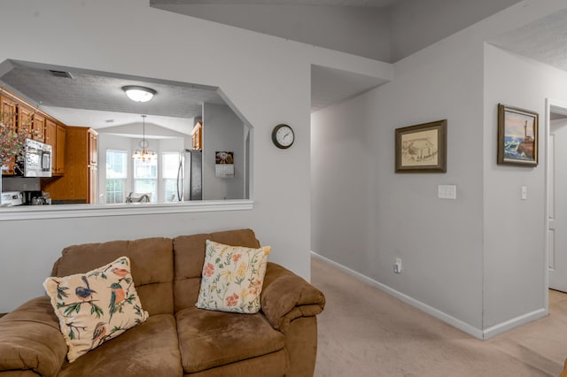 408 Joseph Bryan Way, Lexington, KY 40514 - living room with light carpet, a chandelier, vaulted ceiling, and baseboards
