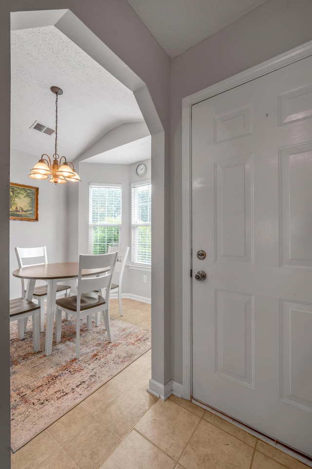 408 Joseph Bryan Way, Lexington, KY 40514 - foyer featuring light tile patterned floors, lofted ceiling, a chandelier, baseboards, and arched walkways