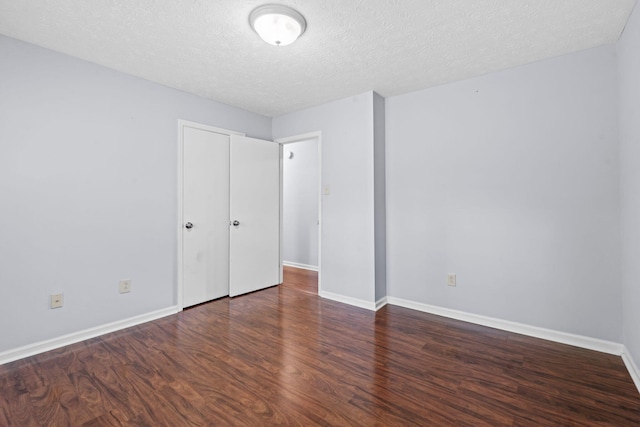 1609 Magna Oak Dr, Lexington, KY 40515 - unfurnished bedroom featuring wood finished floors, a textured ceiling, and baseboards