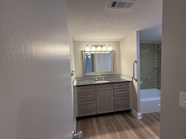175 Malabu Dr Unit 60, Lexington, KY 40503 - full bathroom featuring vanity, wood finished floors, shower / tub combination, and a textured ceiling