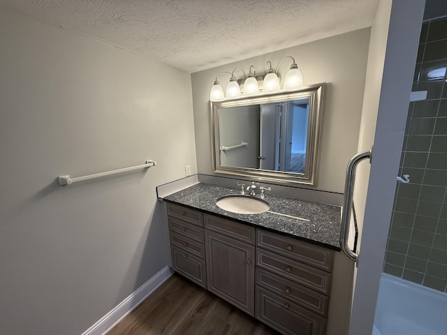175 Malabu Dr Unit 60, Lexington, KY 40503 - full bath with wood finished floors, vanity, a textured ceiling, and baseboards