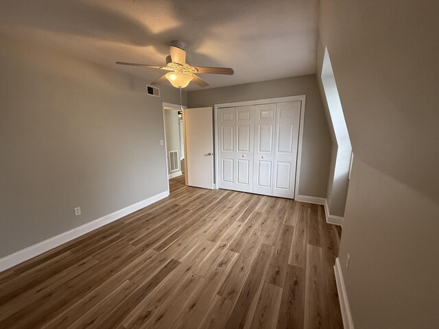 175 Malabu Dr Unit 60, Lexington, KY 40503 - unfurnished bedroom with baseboards, wood finished floors, a closet, and a ceiling fan