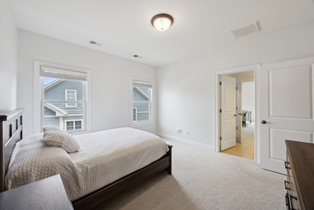 1821 Goodpaster Way, Lexington, KY 40505 - bedroom with multiple windows, light carpet, and baseboards