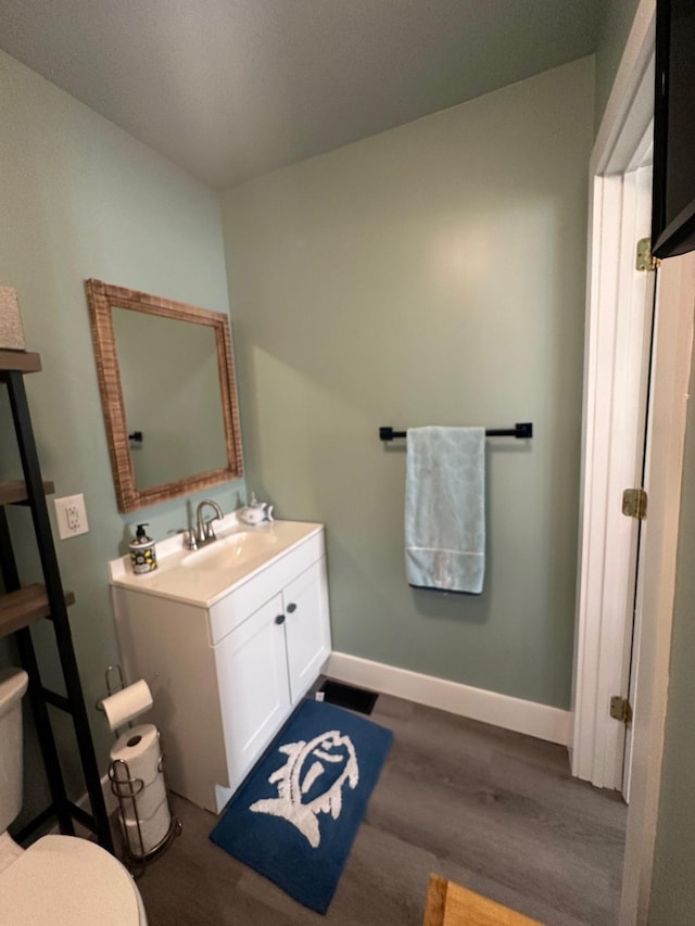 1990 Wells Landing Rd, Danville, KY 40422 - bathroom with vanity, wood finished floors, baseboards, and toilet