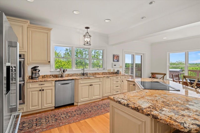 553 White Oak Rd, Stamping Ground, KY 40379 - kitchen with appliances with stainless steel finishes, cream cabinetry, a sink, light wood finished floors, and light stone countertops