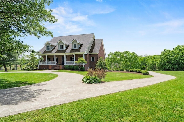 553 White Oak Rd, Stamping Ground, KY 40379 - cape cod home with curved driveway, a porch, brick siding, and a front yard