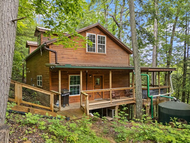 222 Muir Rd, Rogers, KY 41365 - rear view of house featuring log veneer siding, metal roof, and a porch