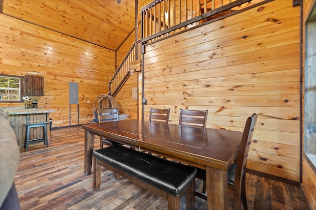 222 Muir Rd, Rogers, KY 41365 - dining area with lofted ceiling, wood finished floors, wooden walls, wooden ceiling, and stairs