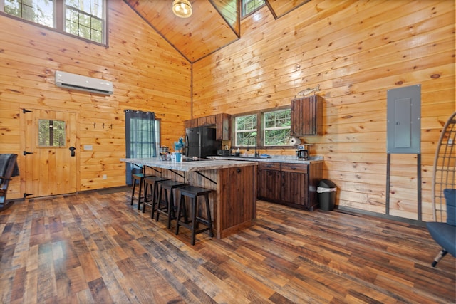 222 Muir Rd, Rogers, KY 41365 - kitchen with electric panel, a wall unit AC, freestanding refrigerator, a kitchen island, and dark wood-style flooring