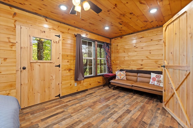 222 Muir Rd, Rogers, KY 41365 - sitting room featuring wood finished floors, wood walls, healthy amount of natural light, wood ceiling, and a ceiling fan