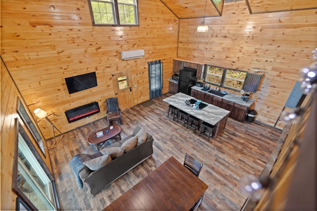 222 Muir Rd, Rogers, KY 41365 - living room with wood walls, wood finished floors, a glass covered fireplace, and high vaulted ceiling