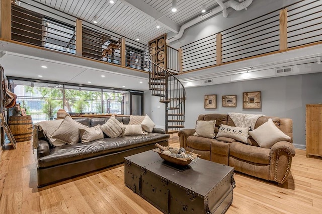517 W Main St, Lexington, KY 40507 - living area with a high ceiling, light wood-style floors, baseboards, beamed ceiling, and stairway