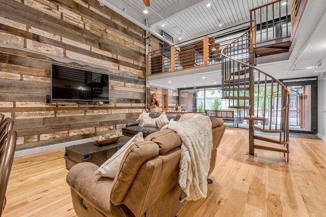 517 W Main St, Lexington, KY 40507 - living room featuring wooden walls, hardwood / wood-style floors, and a high ceiling
