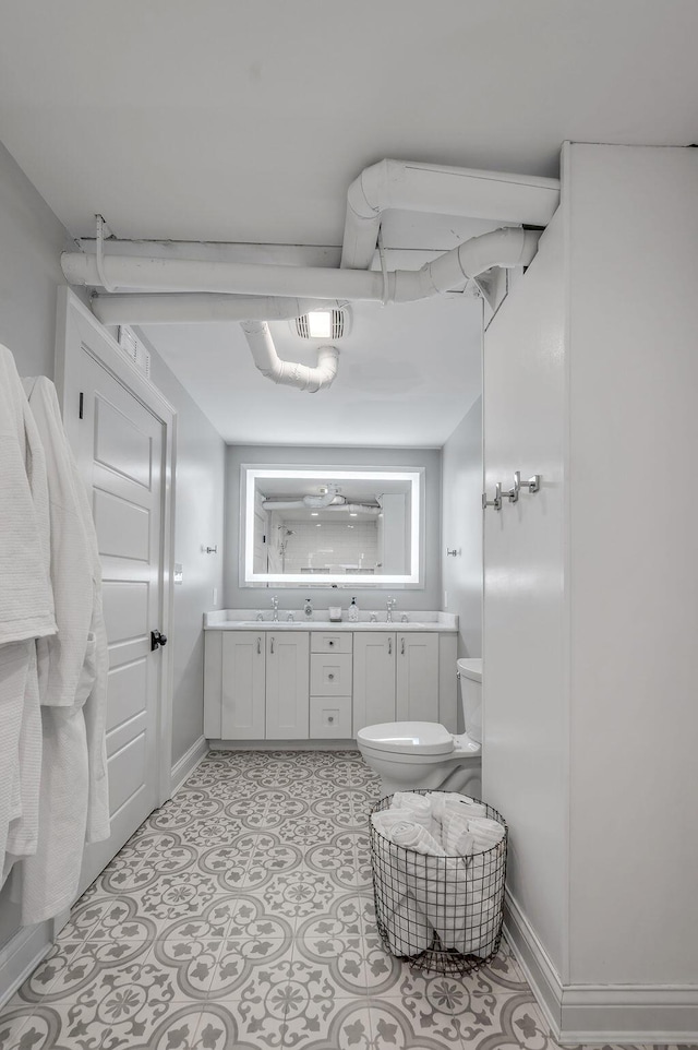 517 W Main St, Lexington, KY 40507 - full bath with toilet, baseboards, vanity, and tile patterned floors