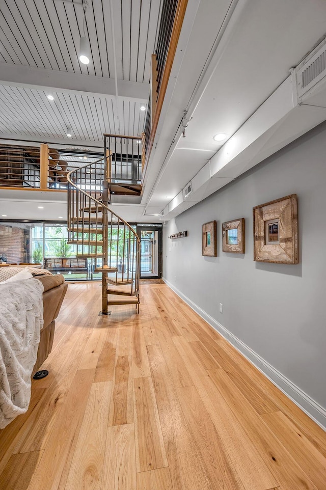 517 W Main St, Lexington, KY 40507 - corridor featuring baseboards, wood finished floors, and stairs
