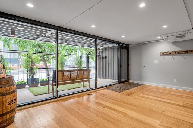517 W Main St, Lexington, KY 40507 - spare room with wood-type flooring, baseboards, recessed lighting, and floor to ceiling windows