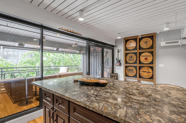 517 W Main St, Lexington, KY 40507 - kitchen with plenty of natural light, dark stone countertops, dark brown cabinetry, and french doors