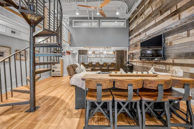 517 W Main St, Lexington, KY 40507 - dining space with stairs, a towering ceiling, ceiling fan, wood finished floors, and baseboards
