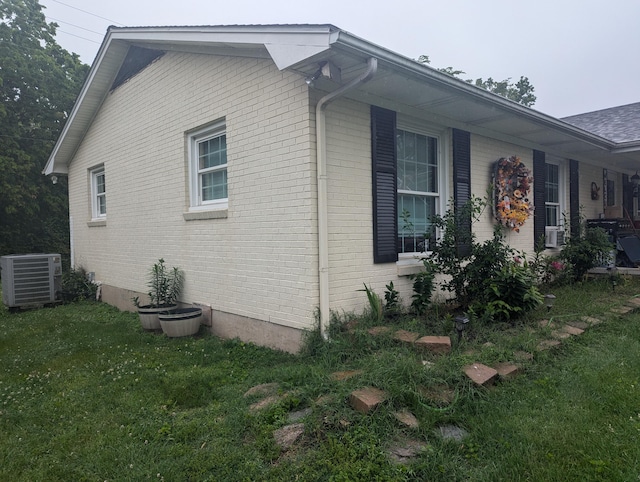 400 Verna Dr, Winchester, KY 40391 - view of side of home featuring brick siding, a yard, and central AC