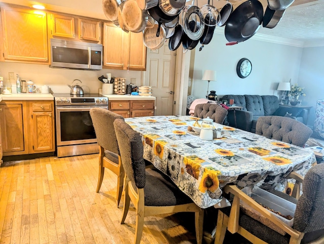 400 Verna Dr, Winchester, KY 40391 - kitchen with appliances with stainless steel finishes, crown molding, light countertops, light wood finished floors, and open floor plan