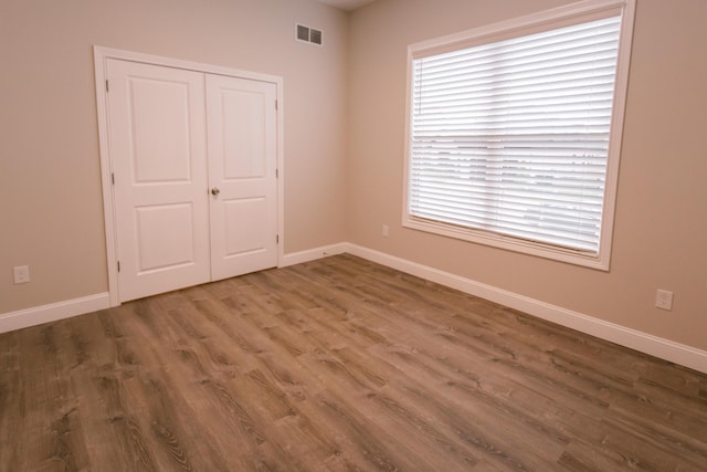 4299 Captains Ct, Lexington, KY 40513 - unfurnished bedroom with wood finished floors, baseboards, and a closet