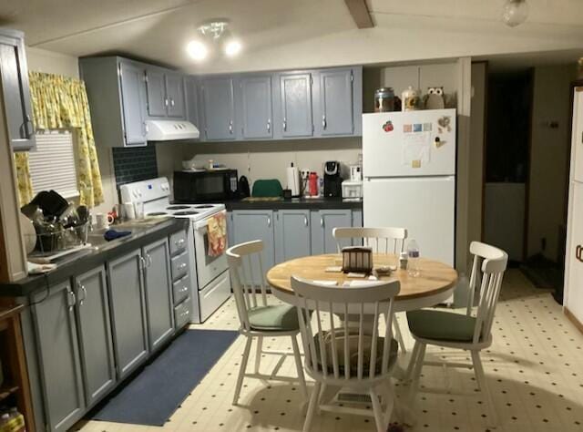700 Rube Brown Rd, Hustonville, KY 40437 - kitchen with white appliances, ventilation hood, light floors, dark countertops, and vaulted ceiling