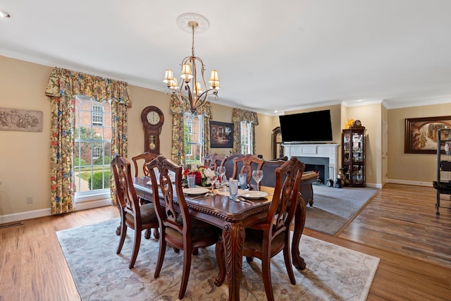 6A Charleston Greene, Danville, KY 40422 - dining space featuring a chandelier, ornamental molding, baseboards, wood finished floors, and a fireplace