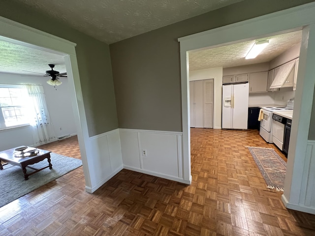 155 Greenfield Subdivision, Corbin, KY 40701 - kitchen featuring white appliances, a textured ceiling, light countertops, a ceiling fan, and wainscoting