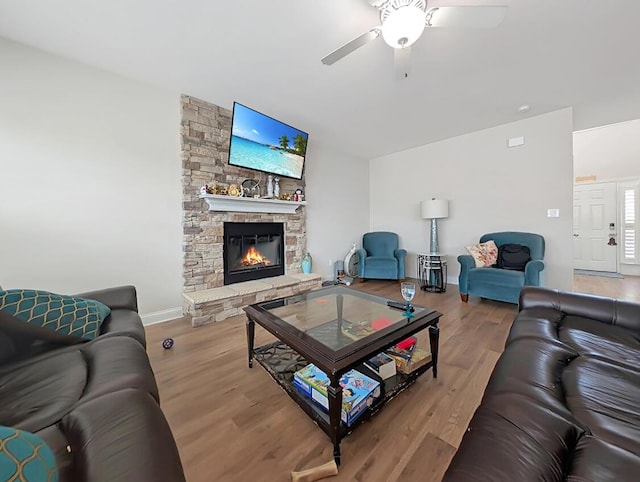 4663 Larkhill Ln, Lexington, KY 40509 - living room with a ceiling fan, wood finished floors, a stone fireplace, and baseboards