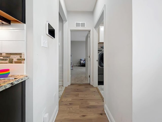 4663 Larkhill Ln, Lexington, KY 40509 - corridor with light wood-type flooring, washer / dryer, and baseboards