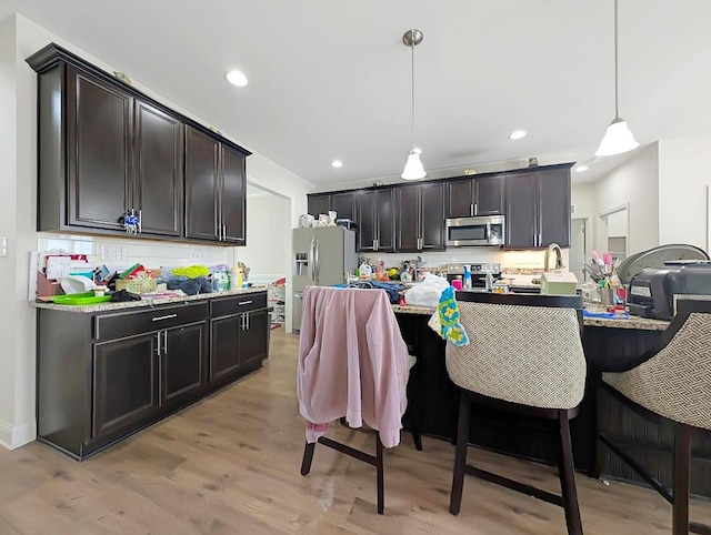 4663 Larkhill Ln, Lexington, KY 40509 - kitchen with appliances with stainless steel finishes, decorative backsplash, decorative light fixtures, light wood-style floors, and recessed lighting