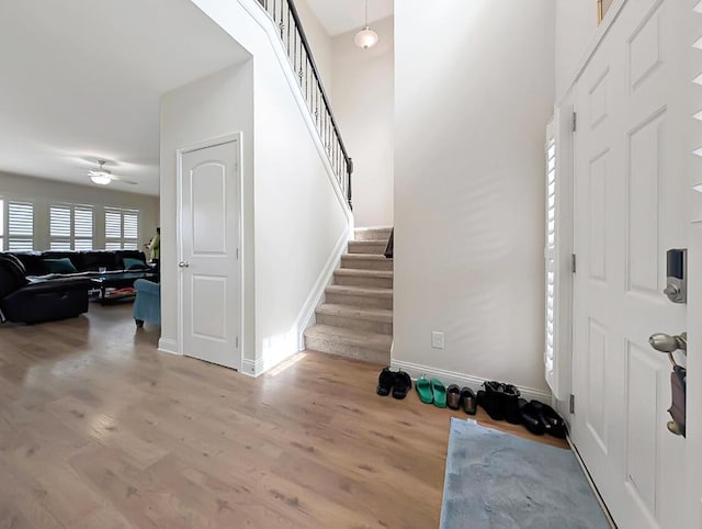 4663 Larkhill Ln, Lexington, KY 40509 - foyer with stairway, wood finished floors, baseboards, and ceiling fan