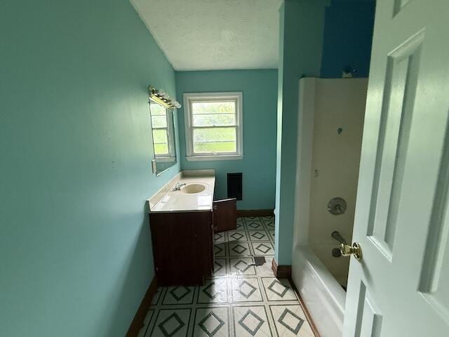 100 Ridgeway Dr, Lancaster, KY 40444 - bathroom featuring baseboards, vanity, tile patterned flooring, a textured ceiling, and shower / washtub combination