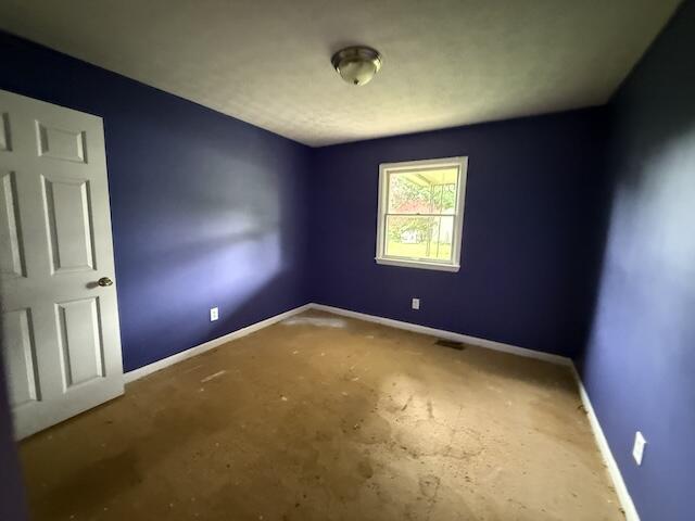 100 Ridgeway Dr, Lancaster, KY 40444 - empty room with baseboards and concrete flooring