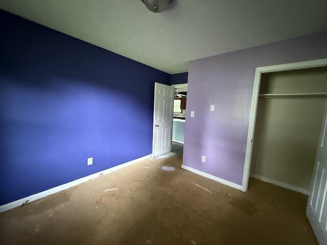100 Ridgeway Dr, Lancaster, KY 40444 - unfurnished bedroom featuring baseboards, a closet, and unfinished concrete flooring