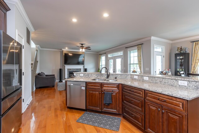 3757 Hardwood Rd, Lexington, KY 40509 - kitchen featuring appliances with stainless steel finishes, a sink, ceiling fan, a fireplace, and ornamental molding