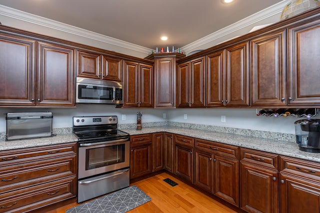 3757 Hardwood Rd, Lexington, KY 40509 - kitchen featuring appliances with stainless steel finishes, light wood-style flooring, ornamental molding, light stone countertops, and recessed lighting