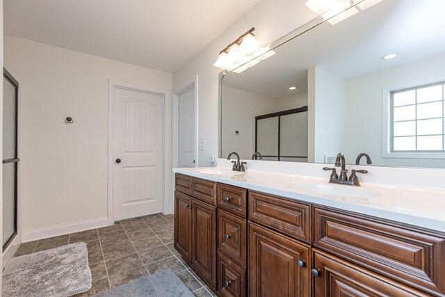 3757 Hardwood Rd, Lexington, KY 40509 - full bathroom with double vanity, a shower with shower door, and baseboards