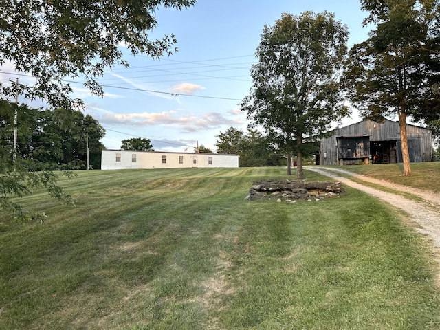 132 Harvieland Rd, Frankfort, KY 40601 - view of green lawn featuring an outdoor structure, a pole building, a detached garage, and driveway