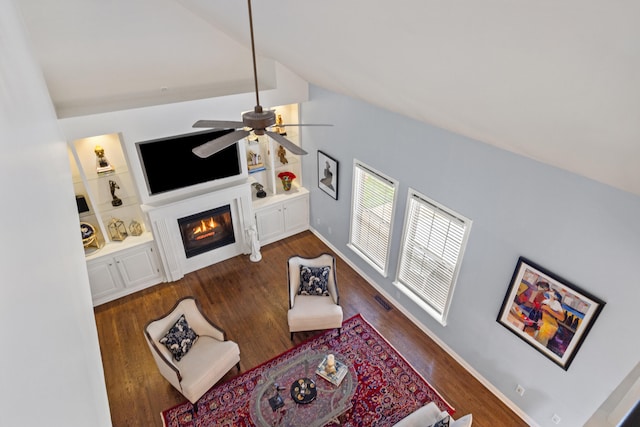 2293 Sunningdale Dr, Lexington, KY 40509 - living room featuring lofted ceiling, wood finished floors, ceiling fan, a glass covered fireplace, and built in shelves