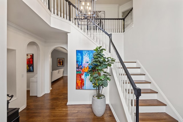 2293 Sunningdale Dr, Lexington, KY 40509 - stairs with a towering ceiling, arched walkways, a chandelier, wood finished floors, and baseboards