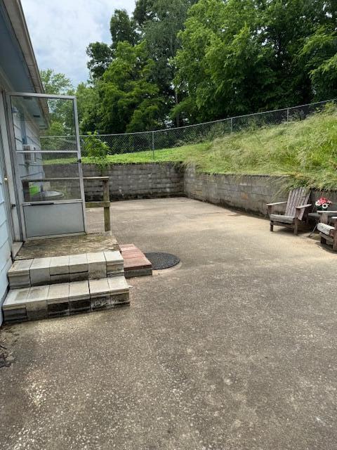 144 N Plum St, Irvine, KY 40336 - fenced backyard featuring a patio