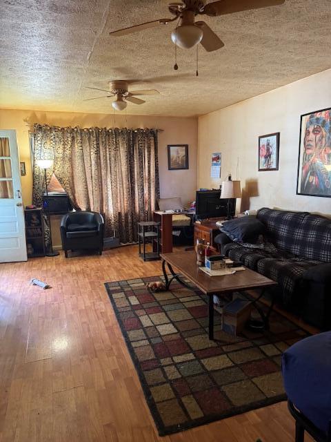 144 N Plum St, Irvine, KY 40336 - living area with a ceiling fan, wood finished floors, and a textured ceiling