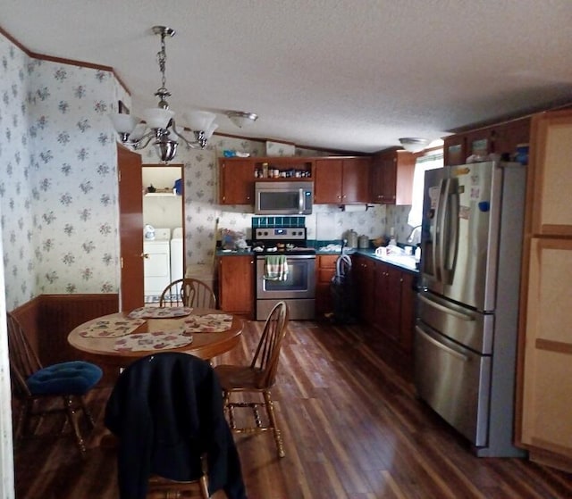 8040 Somerset Rd, London, KY 40741 - kitchen featuring stainless steel appliances, washing machine and clothes dryer, wallpapered walls, dark wood-style floors, and a chandelier