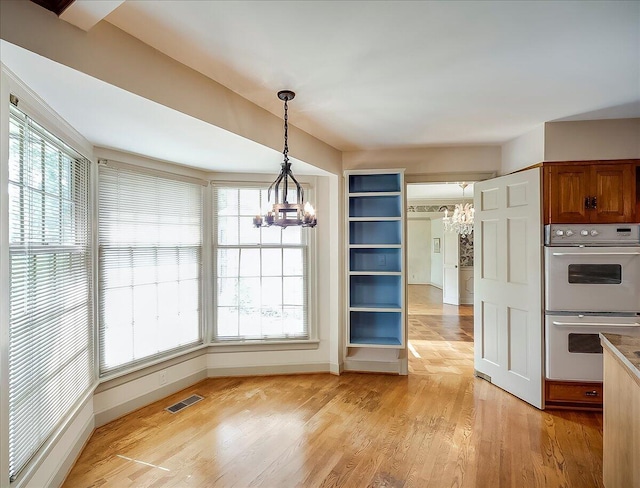 523 Leawood Dr, Frankfort, KY 40601 - unfurnished dining area featuring a chandelier, light wood finished floors, and baseboards